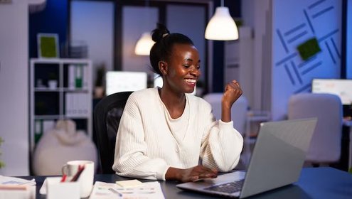 Happy african woman after reading email with good news working late night 482257 5340